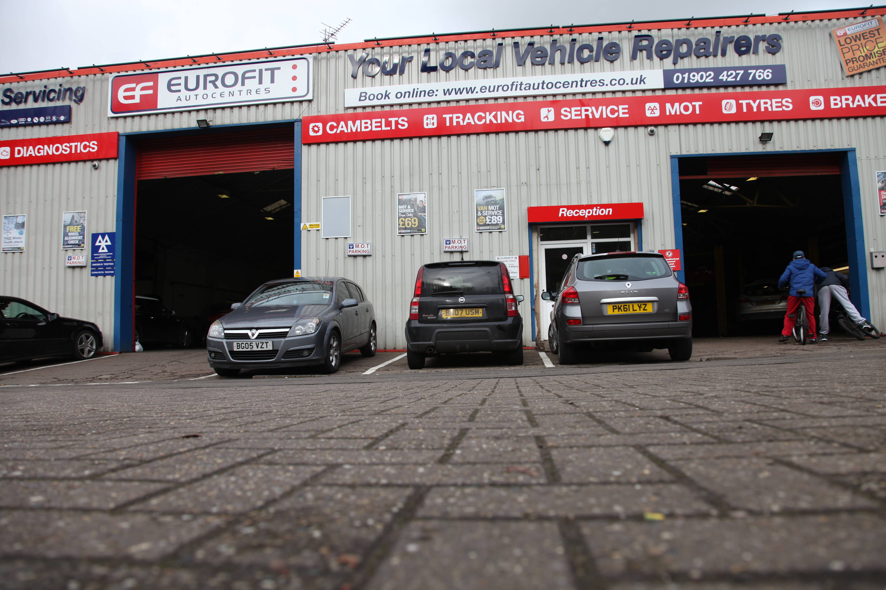Dunstall Eurofit car garage frontage with logos and three cars parked outside 
