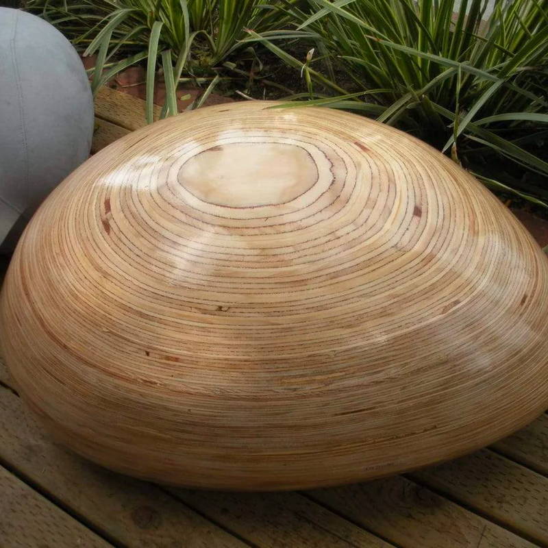 With nods to the rings of a tree, the wooden pebble garden seat is a mesmerizing addition to an outdoor patio. 