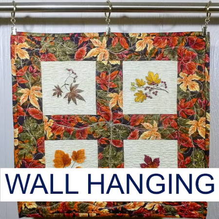 Embroidered quilted wall hanging with autumn leaves, square shape