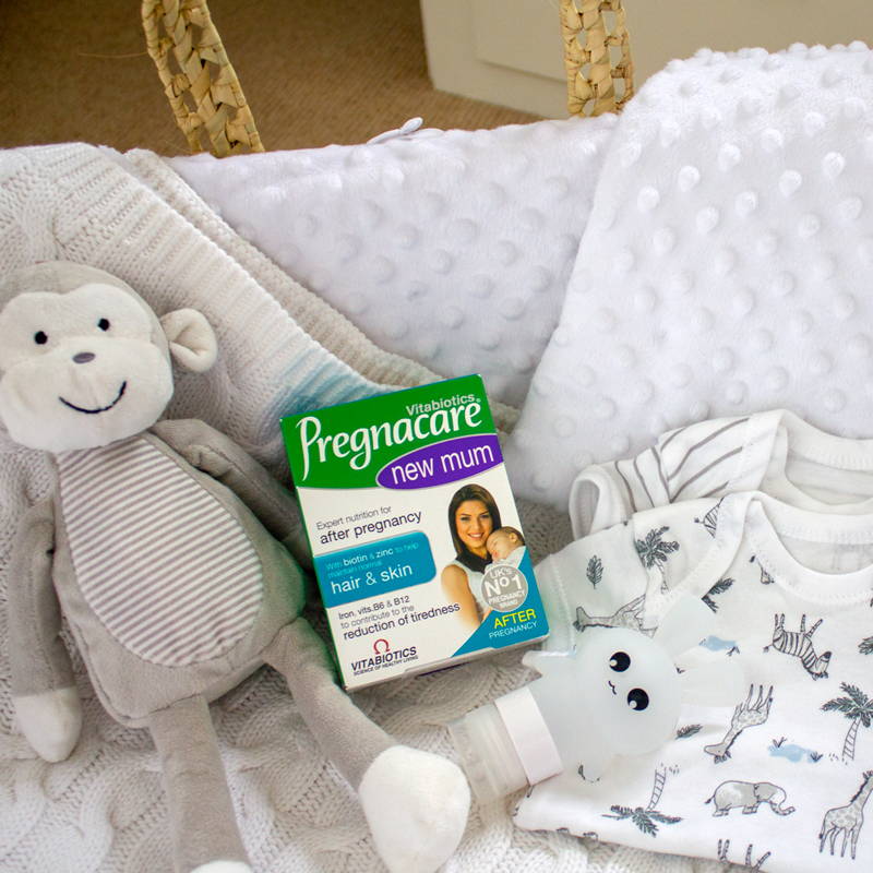 Pregnacare New Mum Product In Baby Cot With Toys And Clothes