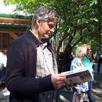 A man reading a book outdoors