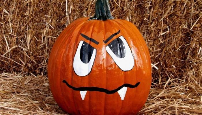 Pumpkin painted with jack o lantern face