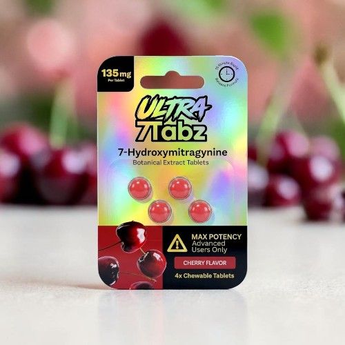 Packaging of Ultra Tabz 7-Hydroxymitragynine capsules with cherries in the background.
