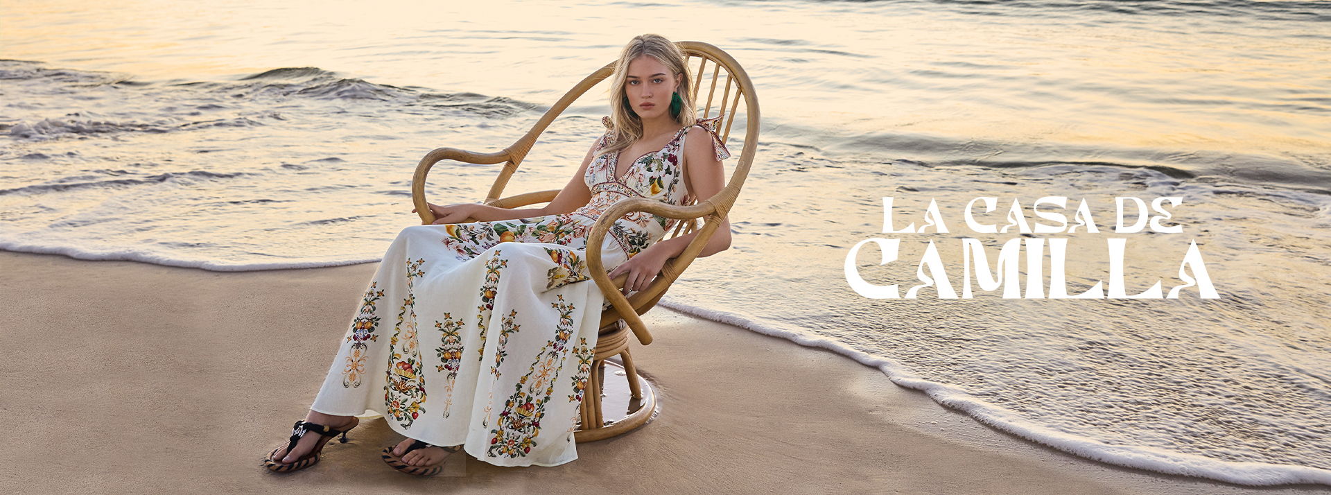 Woman in a rocking chair on the beach at sunset.
