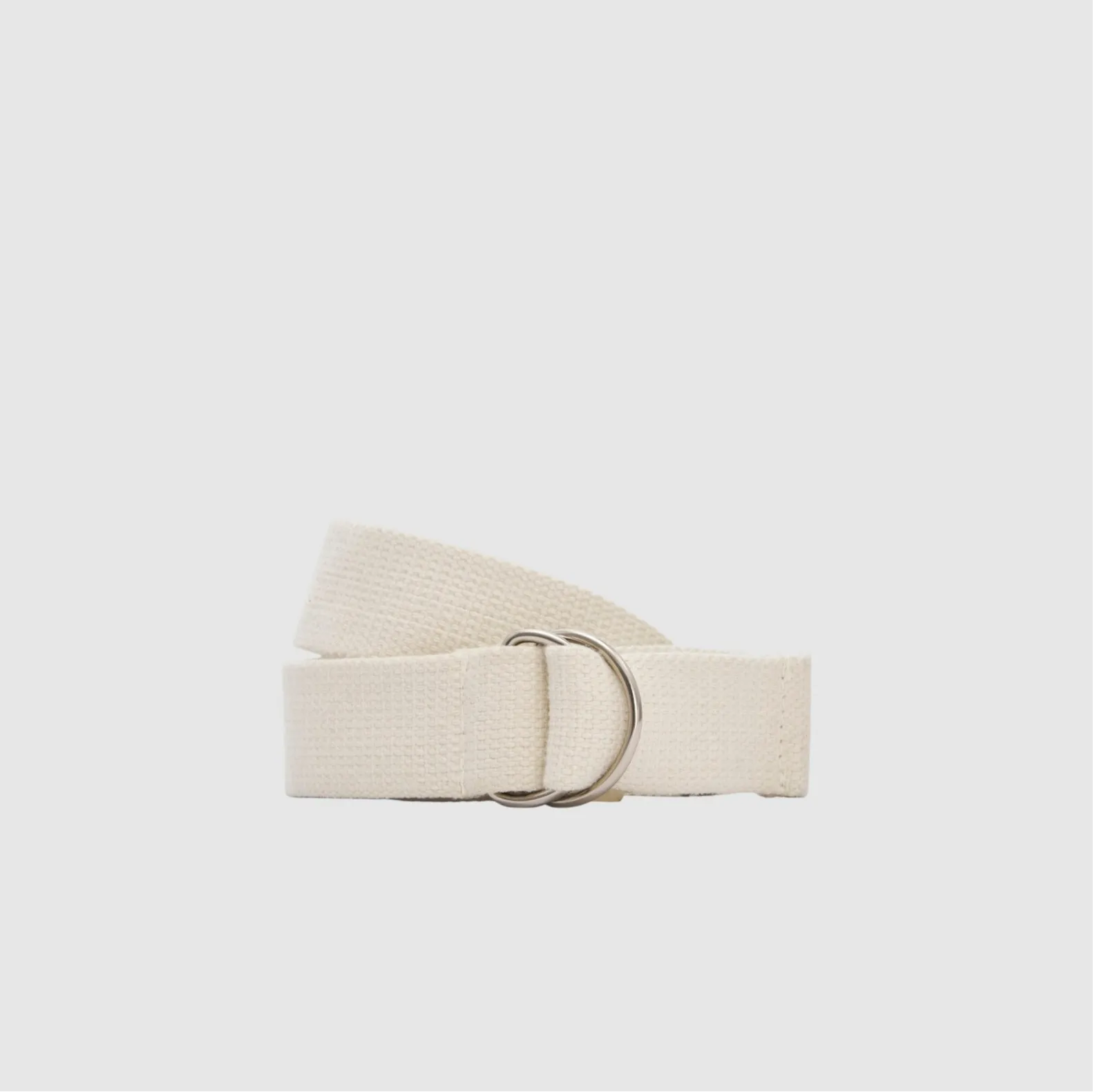 Cream-colored fabric belt with a metal buckle on a light background.