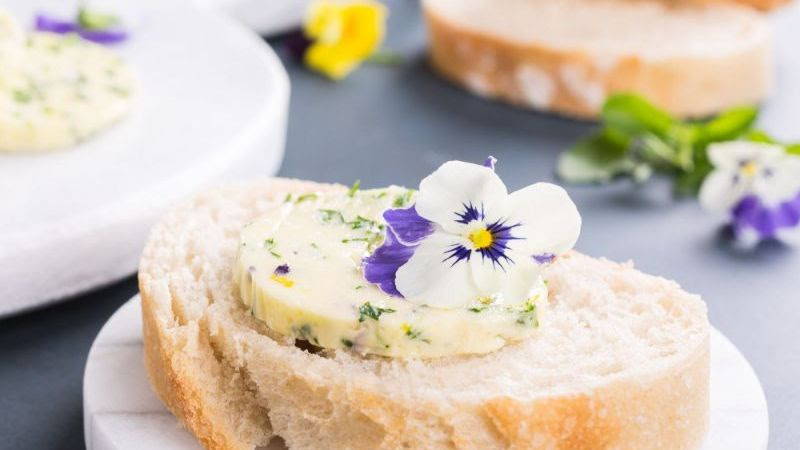 pansy flower on cowboy butter on a bread slice