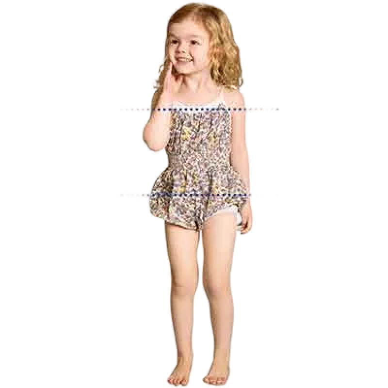Young girl in a colorful swimsuit, smiling and posing playfully.