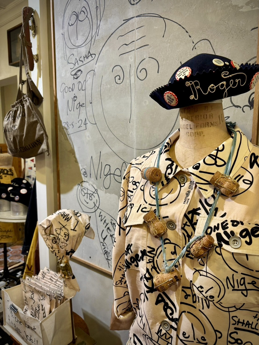A creative display of clothing and accessories in an artistic shop setting.