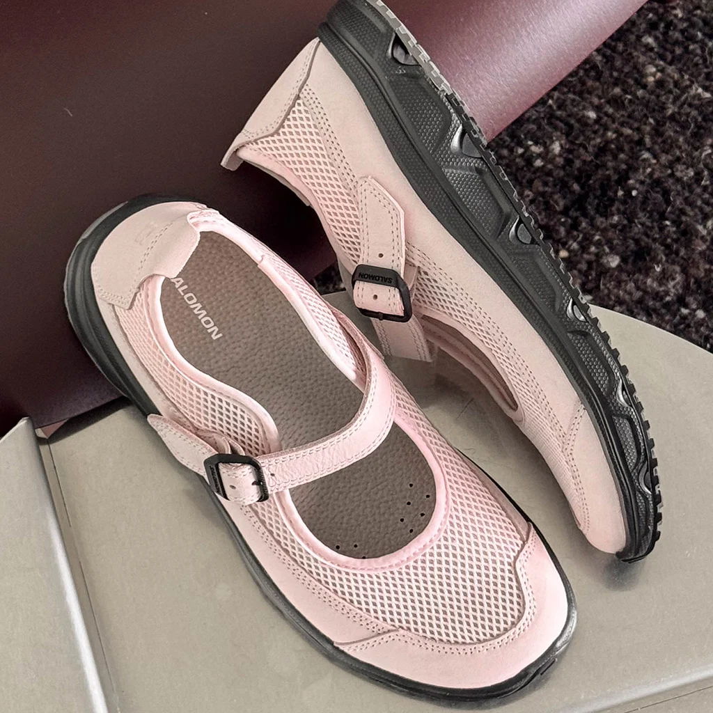 A pair of pink Mary Jane-style shoes on a surface.