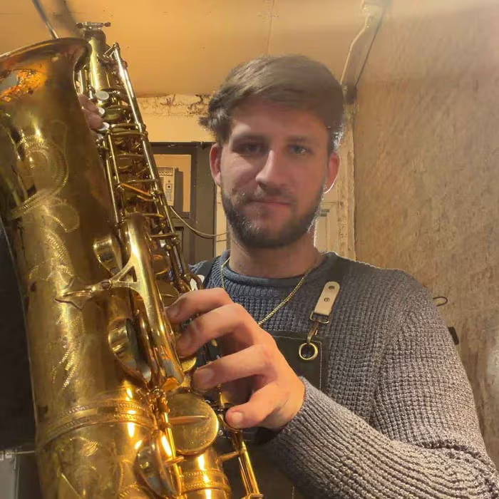 Kyle Bramson repairing a tenor saxophone