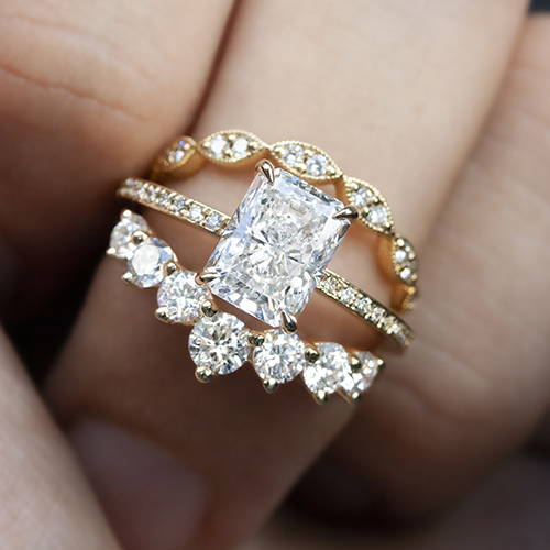 radiant cut diamond ring on hand