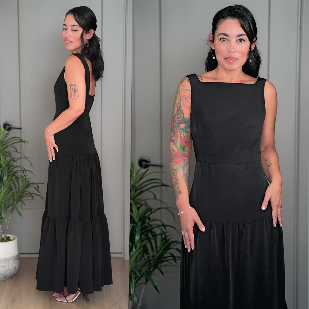 Woman in a black dress posing against a neutral background.