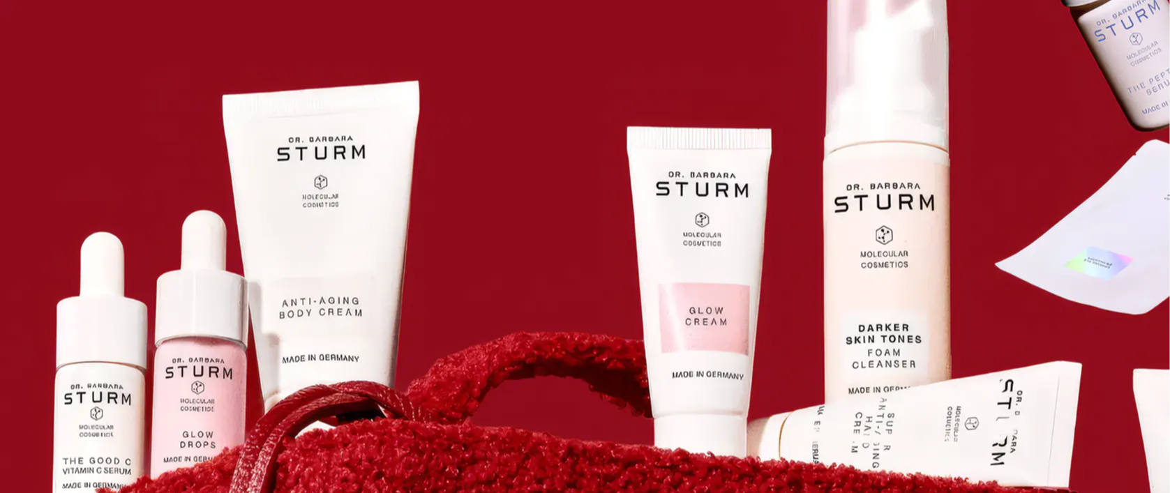 Various skincare products arranged on a red background.