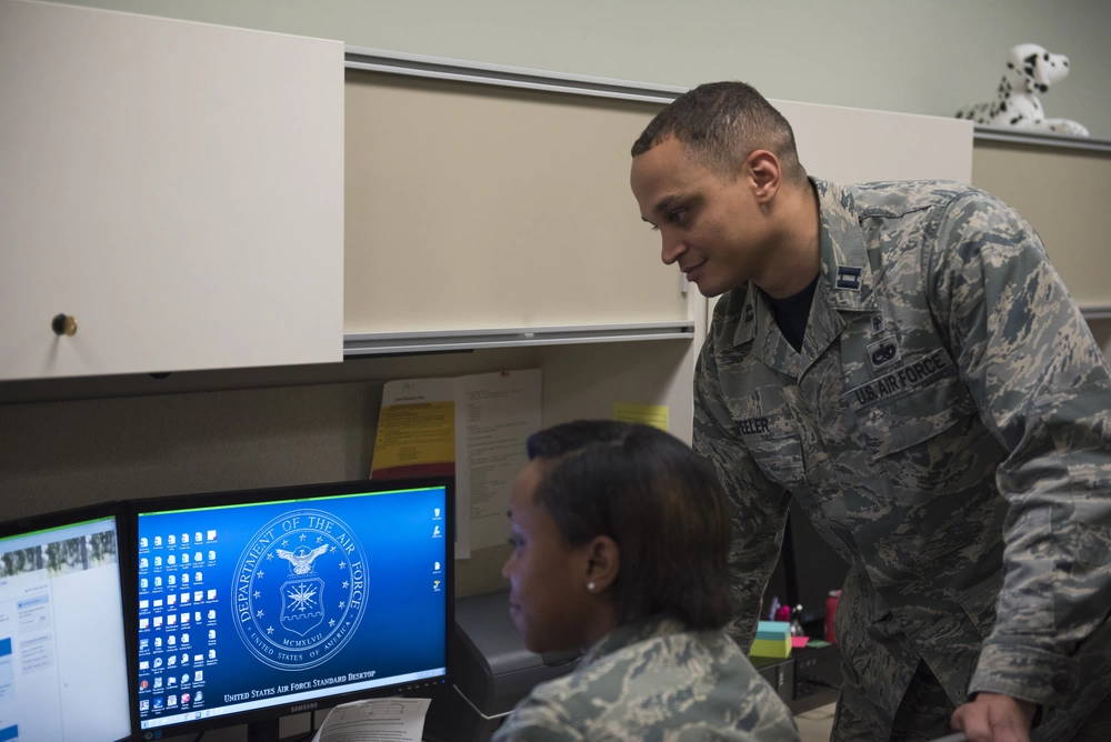 PETERSON AIR FORCE BASE,Colo. – Capt. Marlon Peeler, 21st Medical Group TRICARE operations and patient administration flight chief, explains the TRICARE changes an Airman at Peterson Air Force Base, Colo., Jan. 12, 2018. A full list of TRICARE changes can be found at Tricare.mil/changes. (U.S. Air Force photo by Airman 1st Class Alexis Christian)