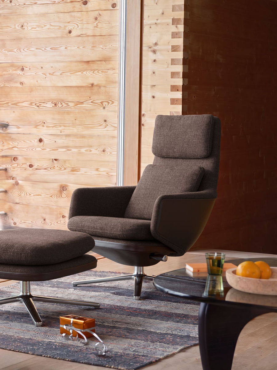 Modern Grand Relax Lounge chair by Vitra and ottoman on a rug in a wooden interior.