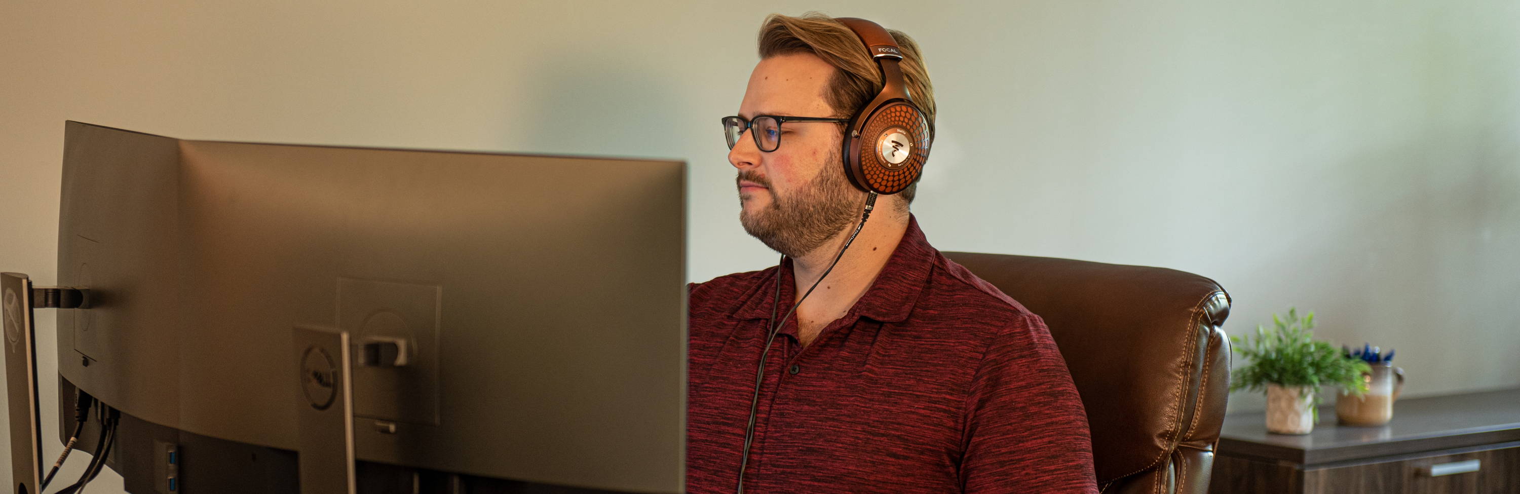 Man at desk with Focal Stellia and Black Dragon Premium Cable