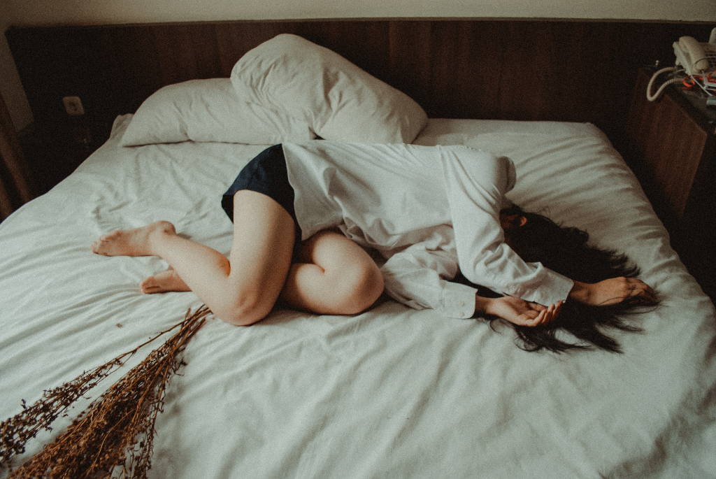 Girl Lying in the bed next to dry plants