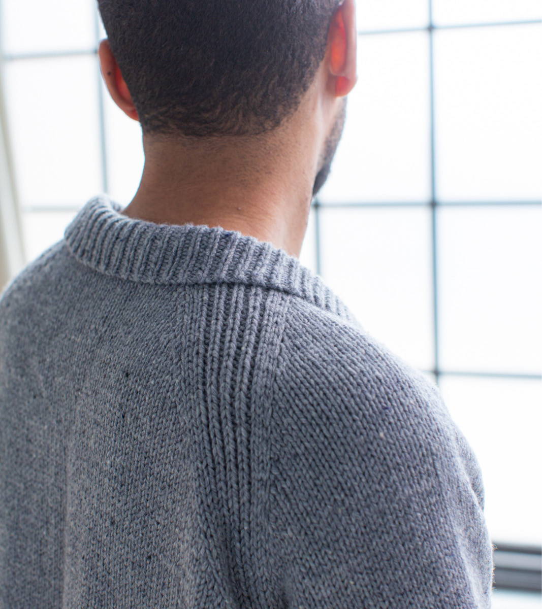 Closeup back shoulder, Anthony modeling First Cardigan Sweater in Ash with Polo Collar