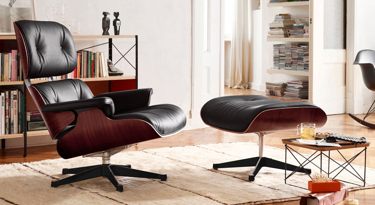 Black leather lounge chair and ottoman in a modern living room setting.