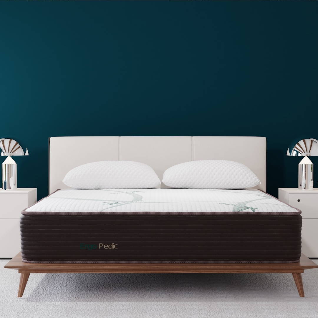 ZenCloud Hybrid mattress in a bedroom with deep teal walls, and white nightstands. The mattress has a dark border and a white cover with a green design