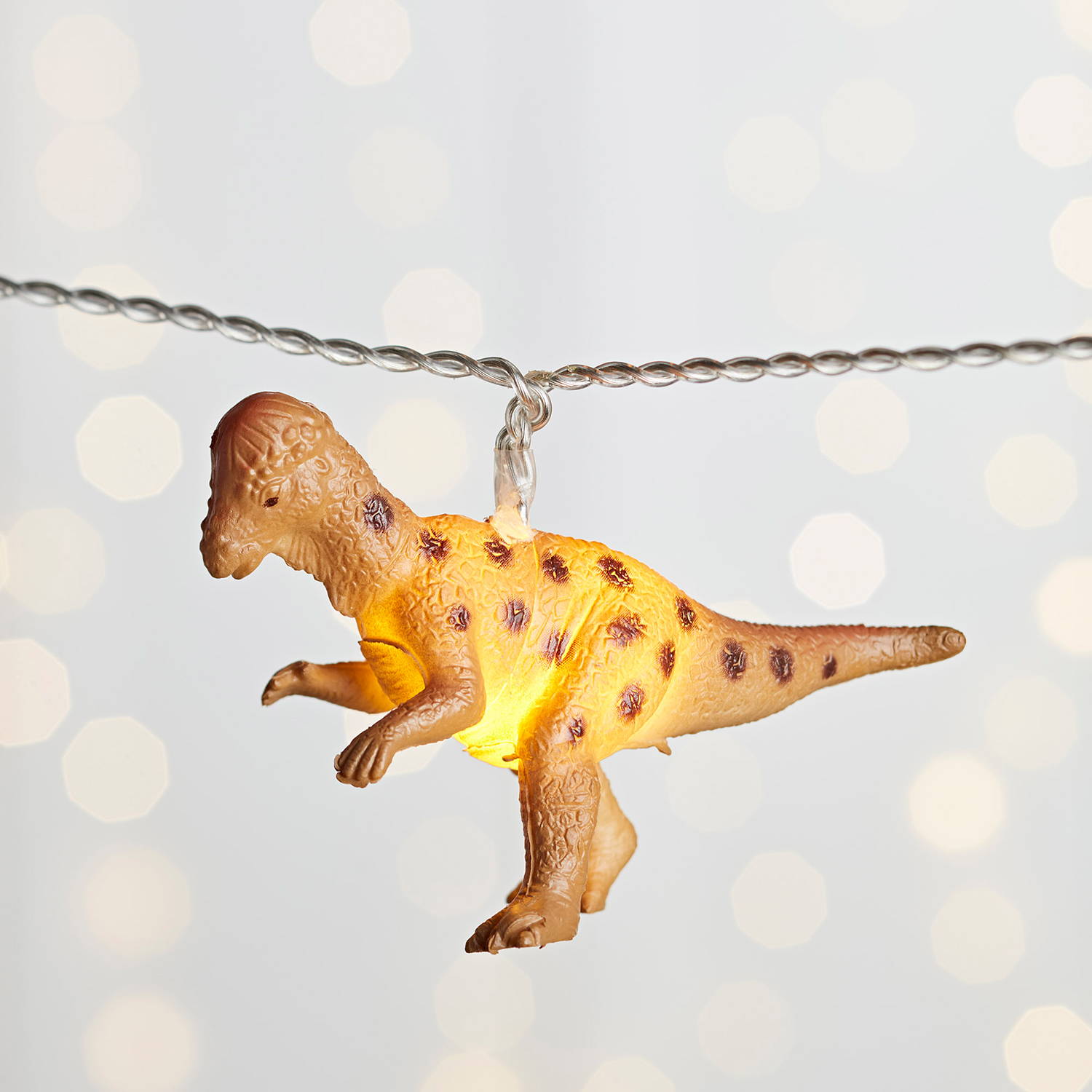 close up of multicoloured dinosaur fairy lights