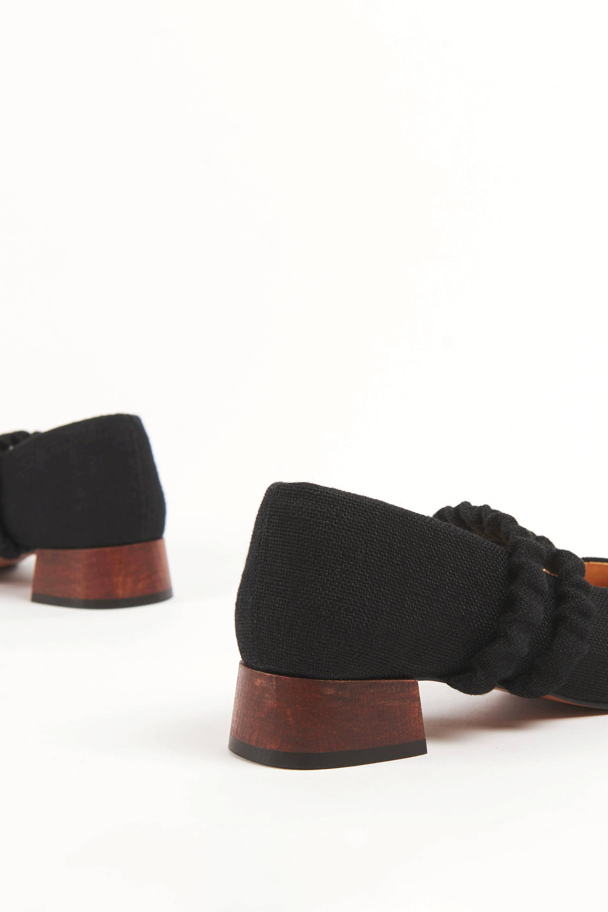 Closeup of Vandrelaar Ruth mary-jane pumps in black linen with elegant block wooden heel