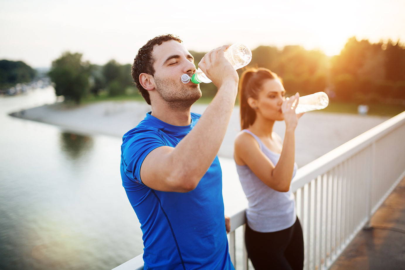 couple drinking water after workout