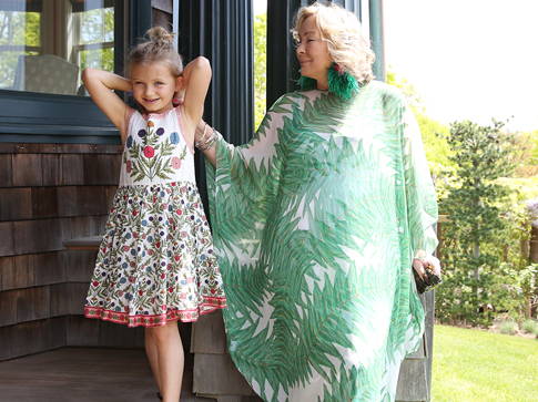 Ala Isham wearing green palm leaf printed bathing suit cover up with her granddaughter in Long Island 