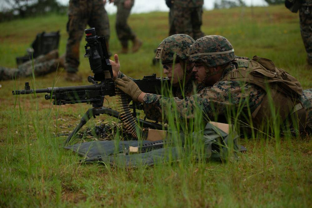 U.S. Marine Corps Lance Cpl. Elliot Blasi, a field artillery fire control Marine, left, and Lance Cpl. Angel Flores, an administrative specialist, both with the 31st Marine Expeditionary Unit (MEU), reload an M240B machine gun during a live-fire exercise on Camp Hansen, Okinawa, Japan, June 13, 2022. Marines applied their knowledge of M249 light machine gun and the M240B weapon systems on the range in order to maintain proficiency and lethality. The 31st MEU, the Marine Corps' only continuously forward-deployed MEU, provides a flexible and lethal force ready to perform a wide range of military operations as the premier crisis response force in the Indo-Pacific region. (U.S. Marine Corps photo by Lance Cpl. Christopher Lape)