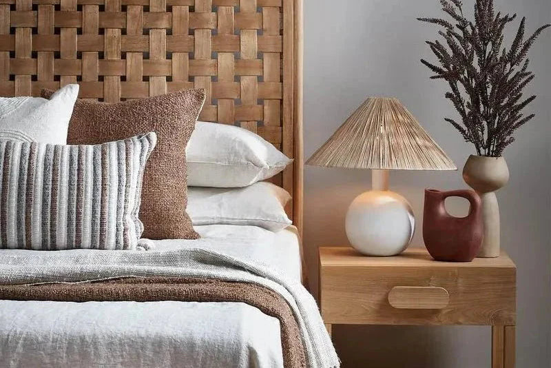 Bedroom with wooden headboard, nightstand, and raffia lamp