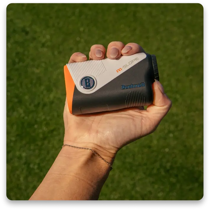 A hand holding a compact device with a black and orange design.