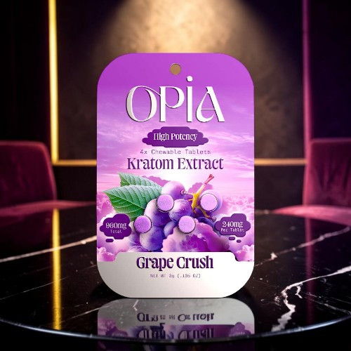 Opia Kratom Extract Grape Crush packaging on a glossy surface.