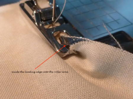 Guide Fabric into the Rolled Hem Foot