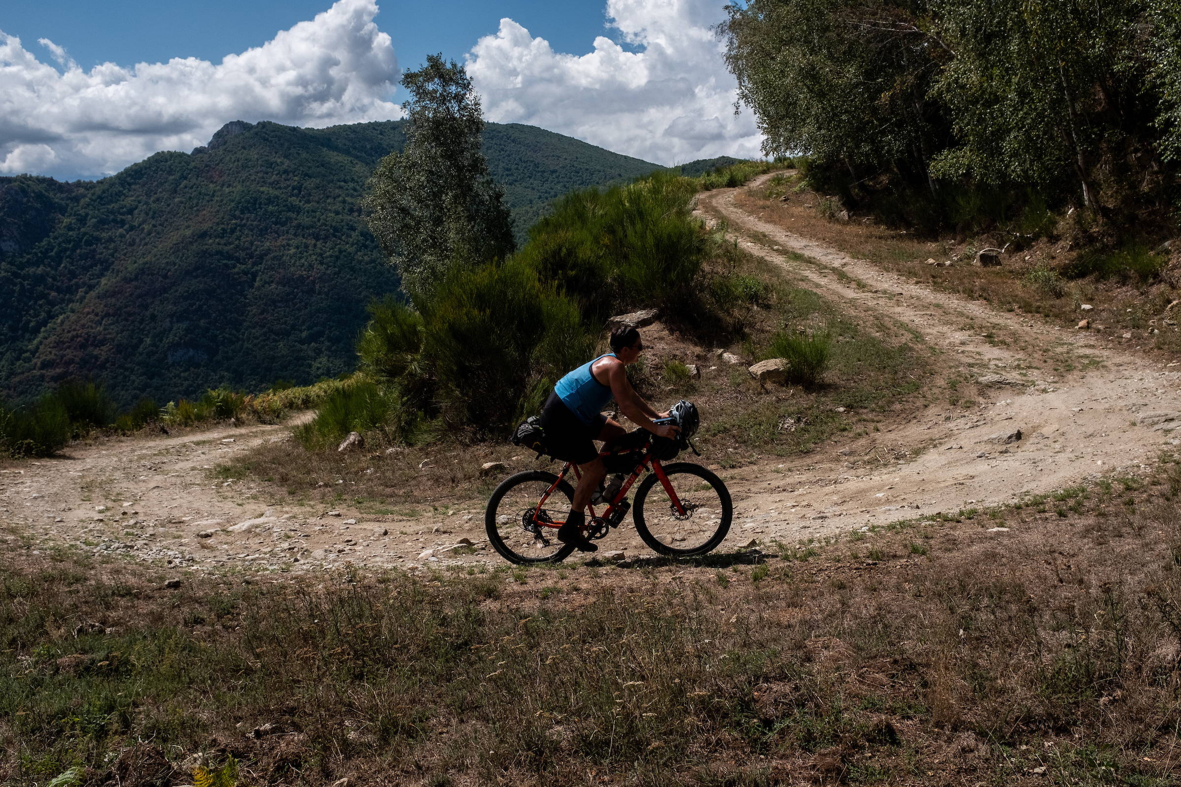 Philippa cycling up an off road track