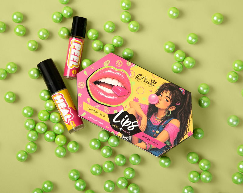 Lip products displayed on a green background with colorful candy balls.