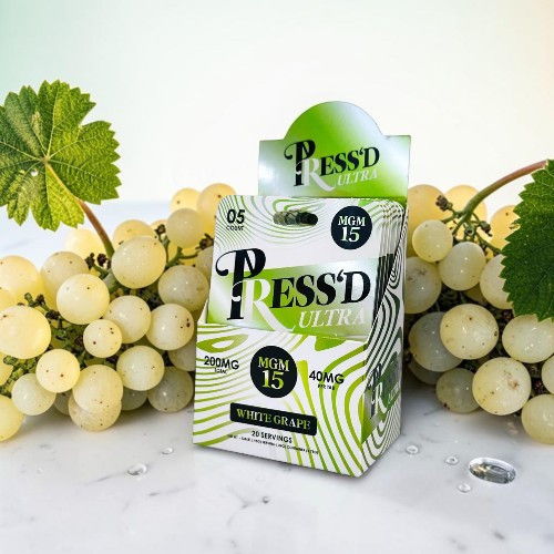 Press'd juice box with grapes in the background.