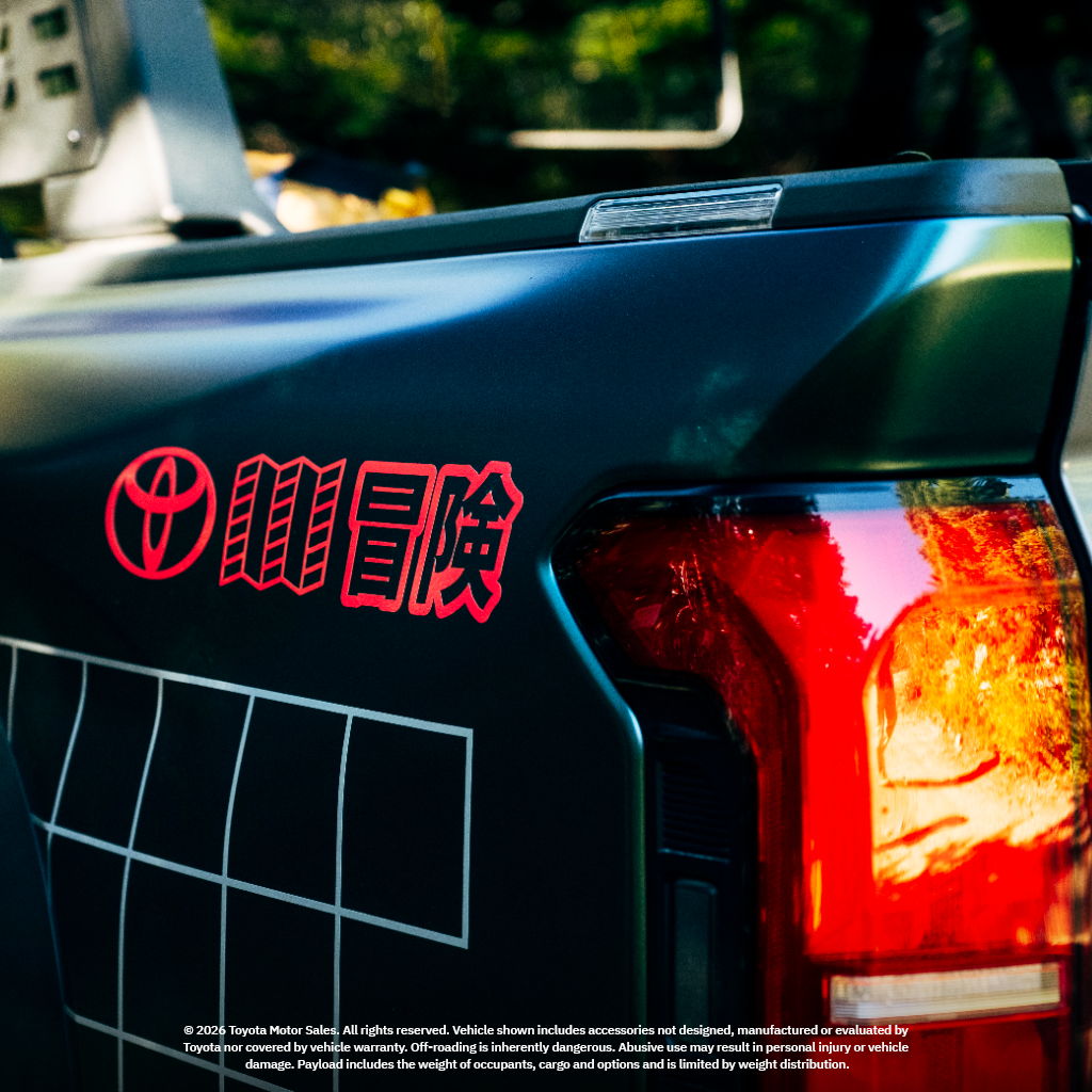 Close-up of a Toyota vehicle's rear with red logo and tail light.