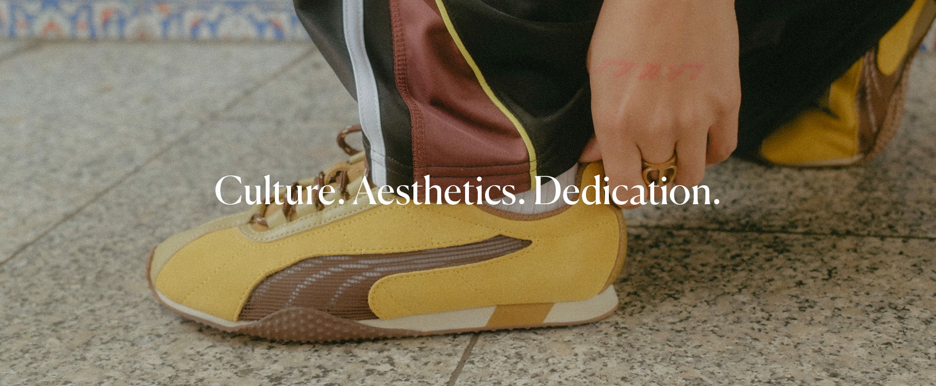 Person adjusting yellow sneakers on a tiled surface with text overlay.