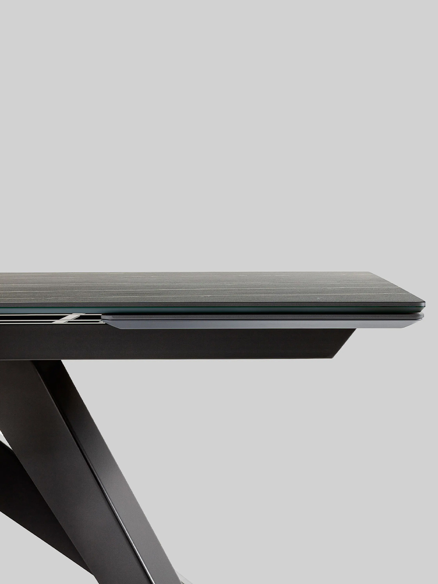 Modern black Big Extendable Table by Bonaldo with a glass top, viewed from the side.