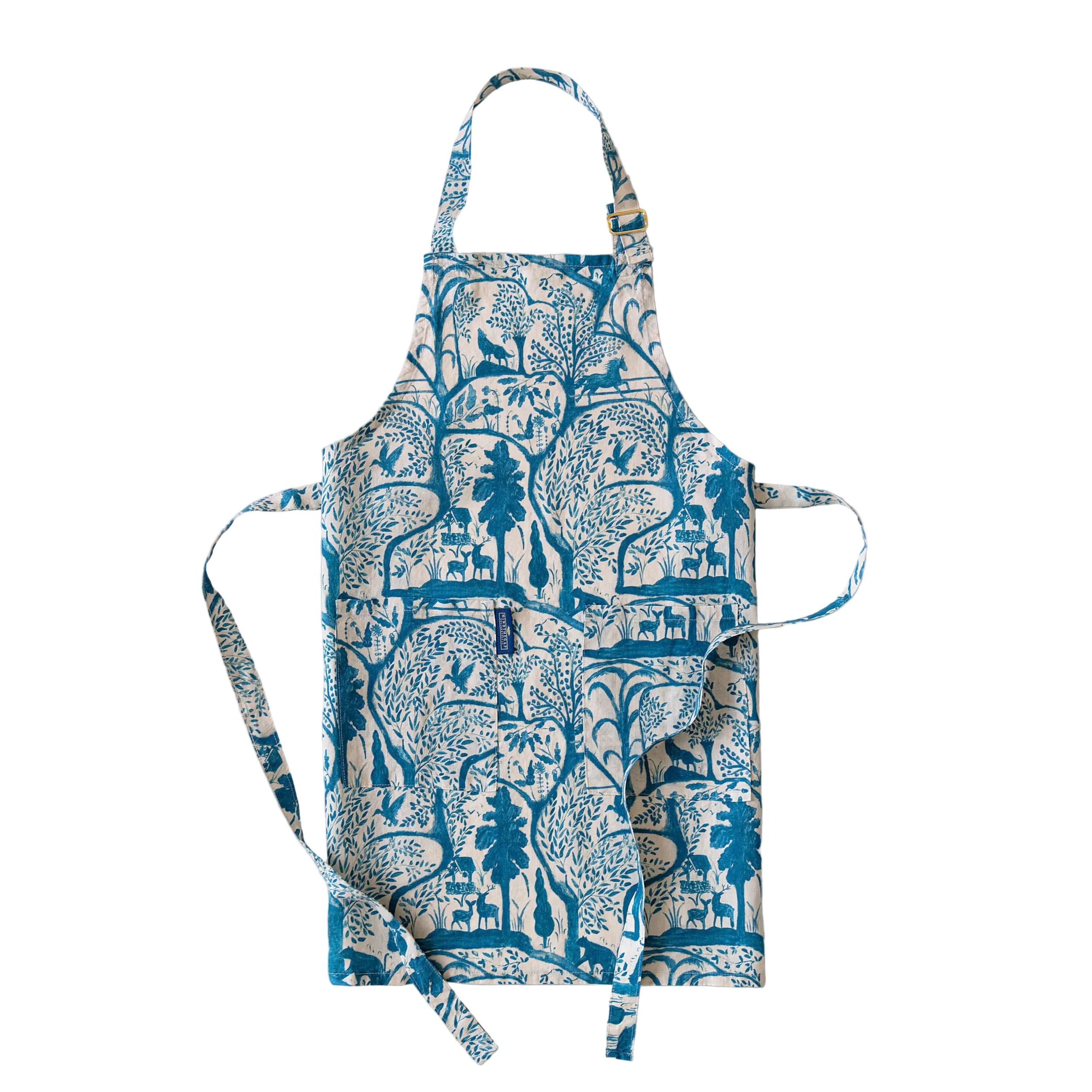 A kitchen apron with a blue and white botanical and animal print, featuring a neck strap, waist ties, and front pockets.