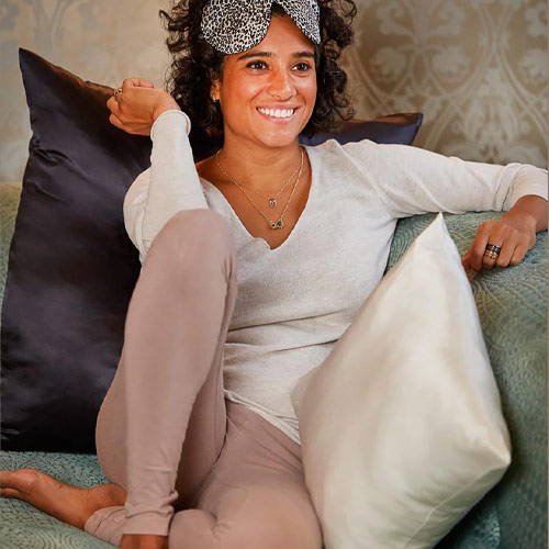 Woman smiling when sitting on pure silk cushion in black and white colour