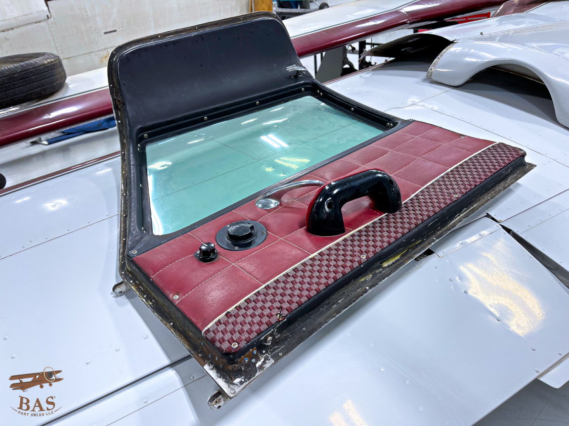 Car hood scoop with a transparent window and handle.