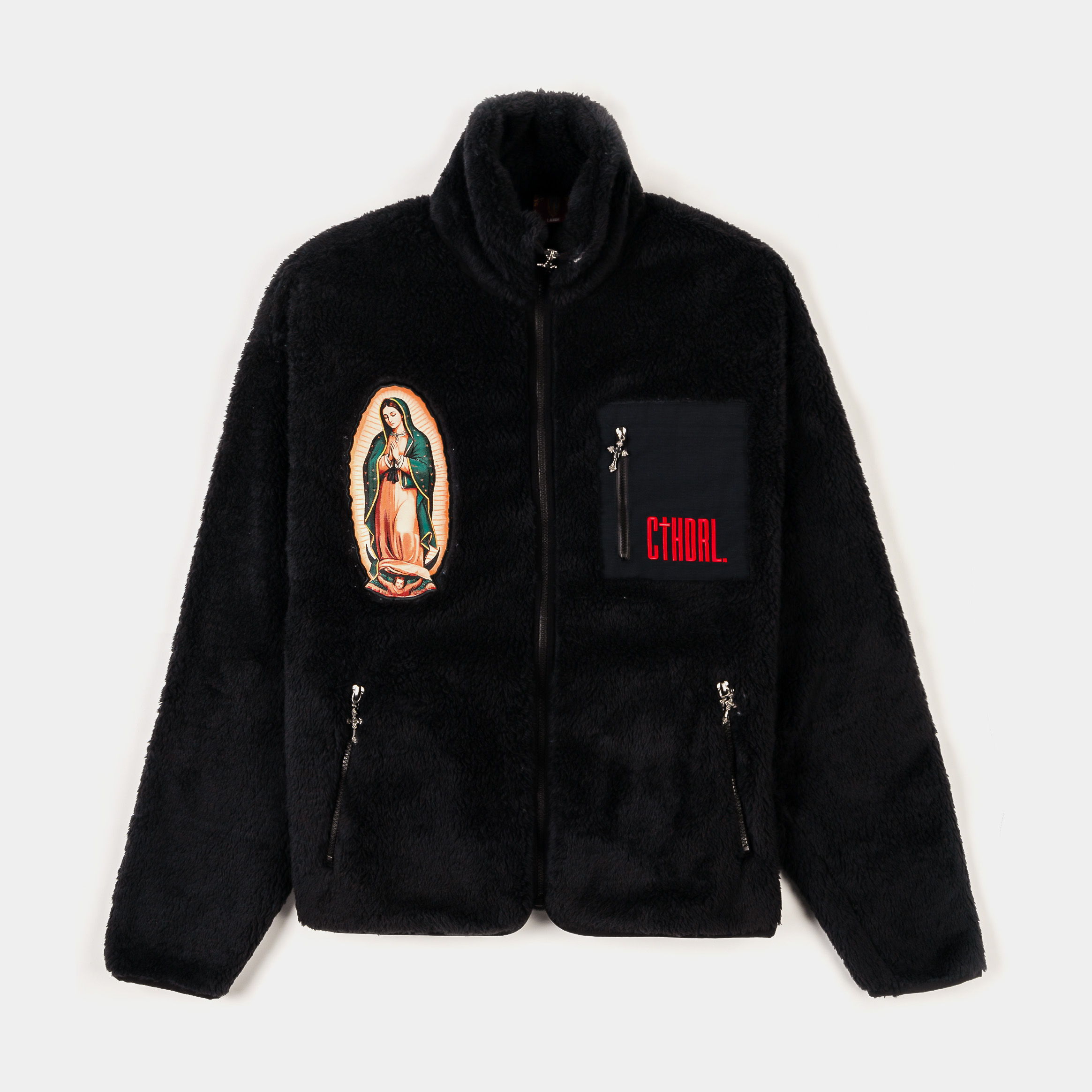 Black faux fur jacket with religious patches and zippered pockets.