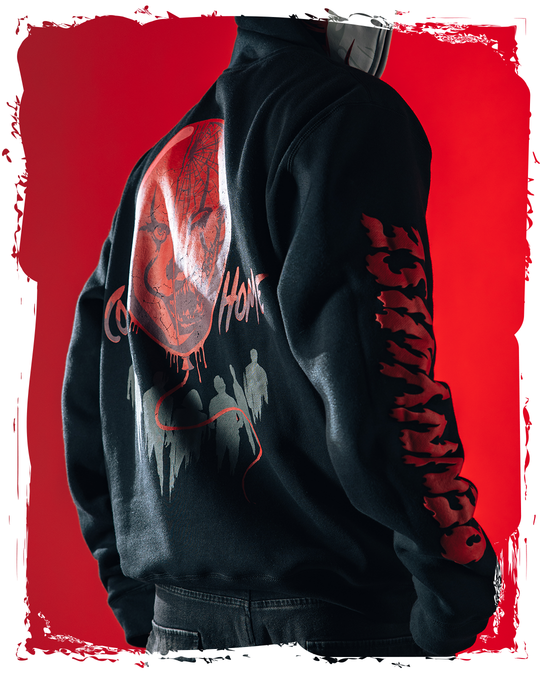 Person wearing a black hoodie with a graphic design and red background.