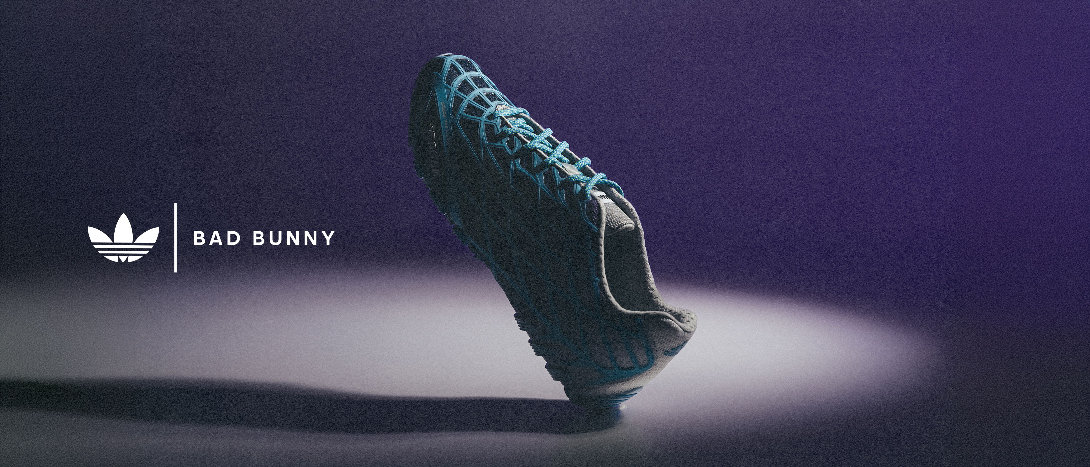 Black athletic shoe with blue accents on a gradient background.