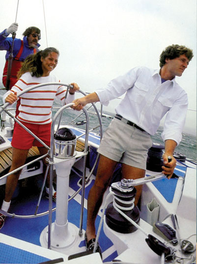 Man and woman sailing on yacht wearing Sportif UPF shorts.