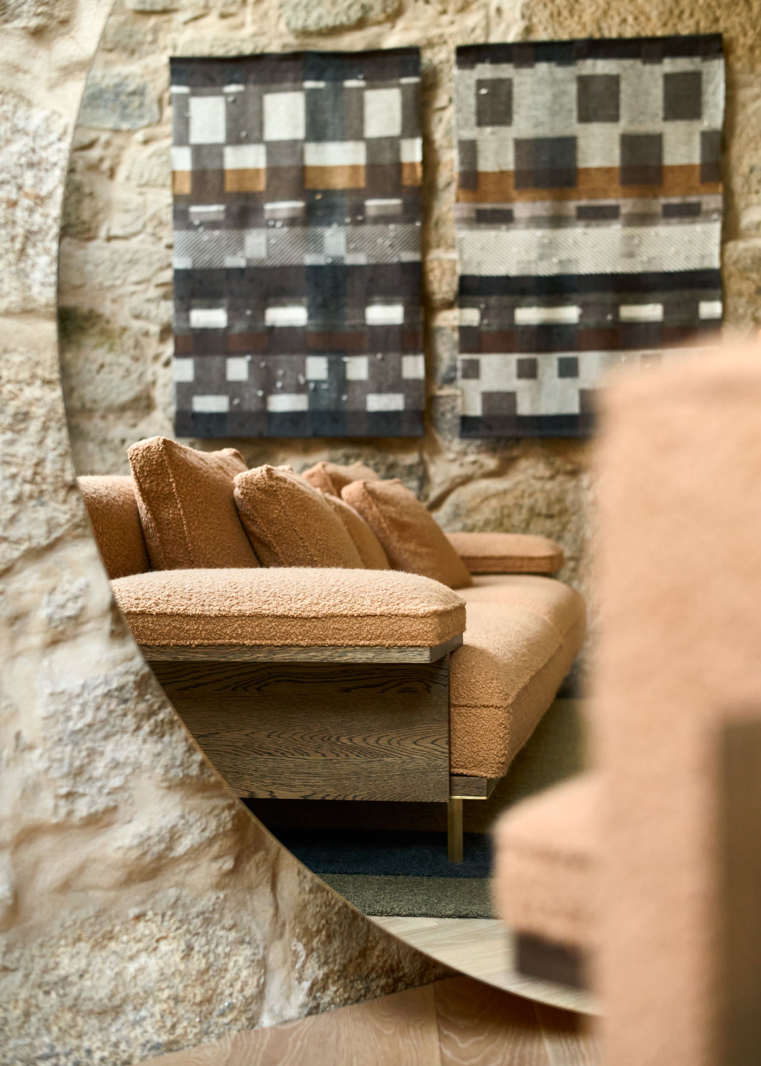A stylish living room with a sofa and decorative wall hangings.