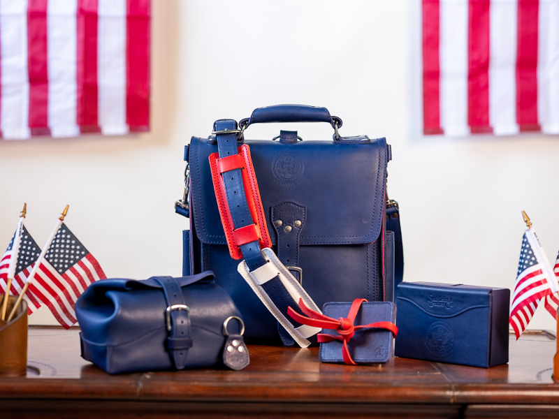 A collection of navy bags with red accents and small American flags.