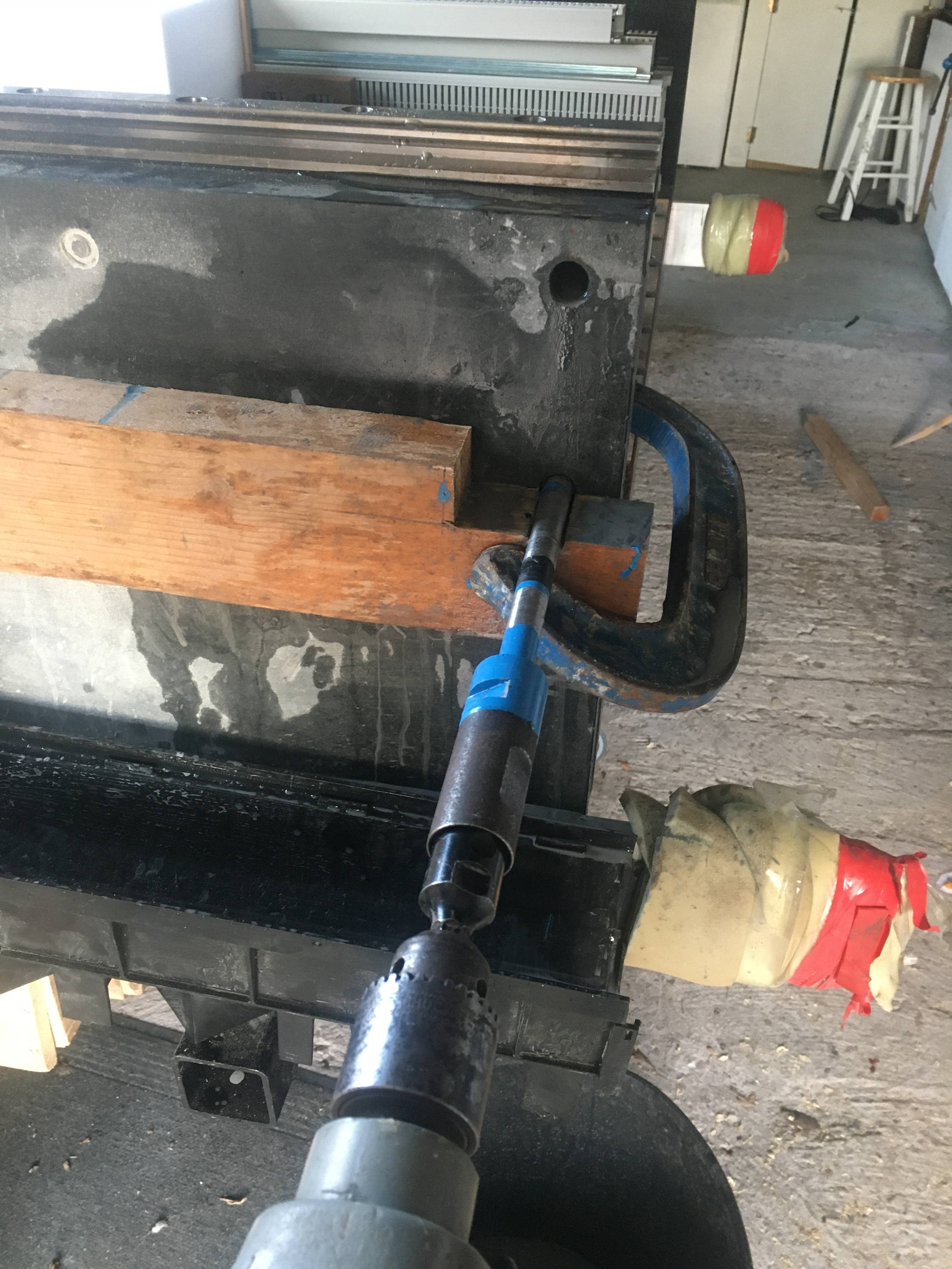 A simple wooden jig used to help align the core drill square and perpendicular to the granite.