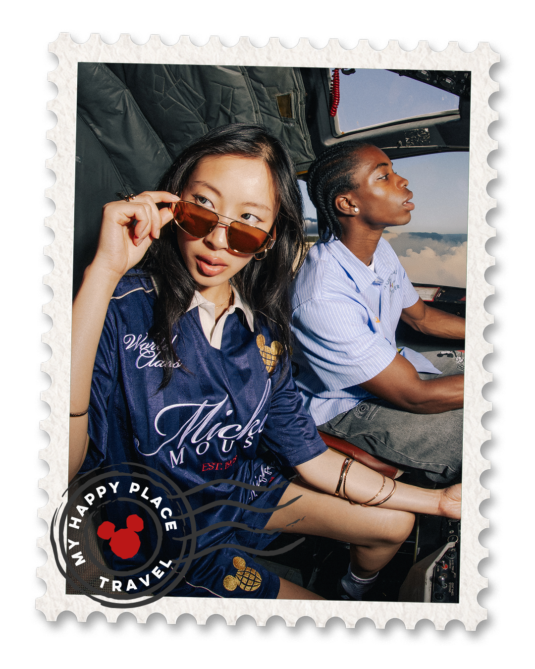 Two people in a cockpit, one wearing sunglasses, with a travel-themed design.